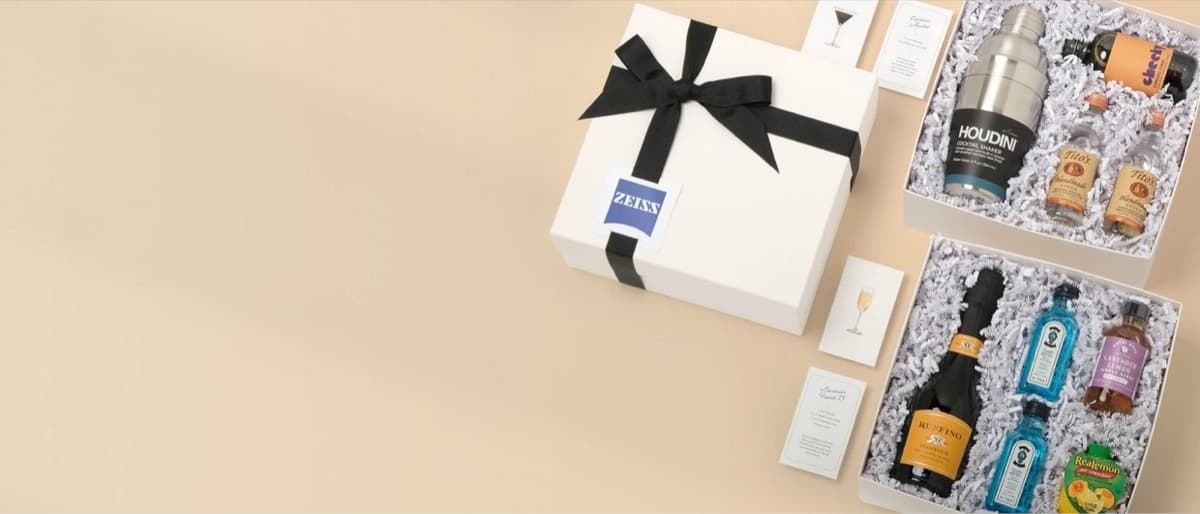 A Fountain gift box with a logo tag next to two cocktail kits